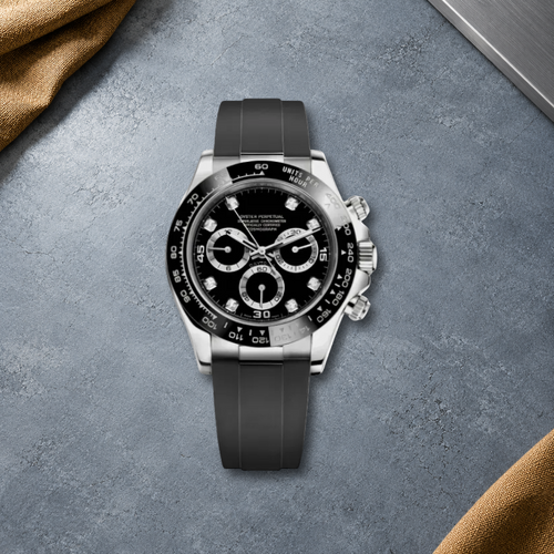 Speedline Gem Black chronograph laid flat on cool blue-gray cement with ochre canvas