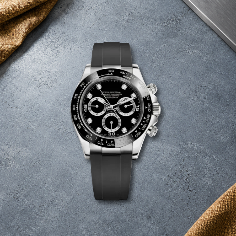 Speedline Gem Black chronograph laid flat on cool blue-gray cement with ochre canvas