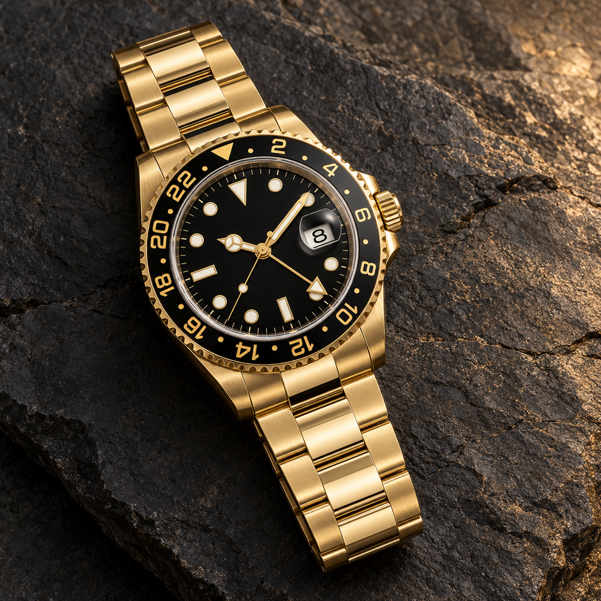 GMT Navigator Imperial Gold with gold Three-Link bracelet laid on dark stone