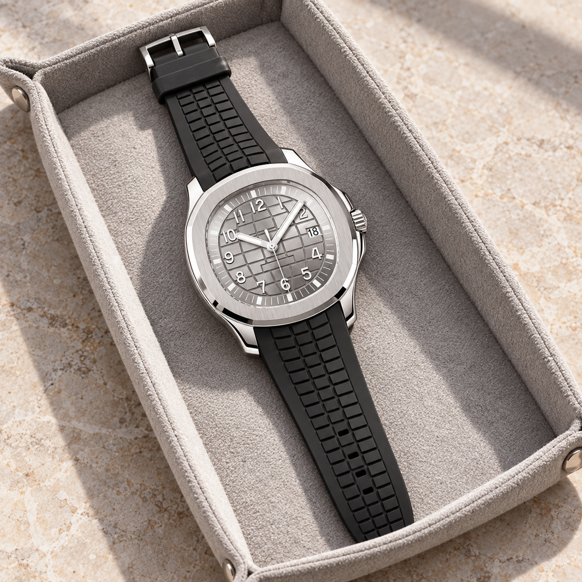 Nautiko Silver with black patterned rubber strap laid in a light woven-fabric tray
