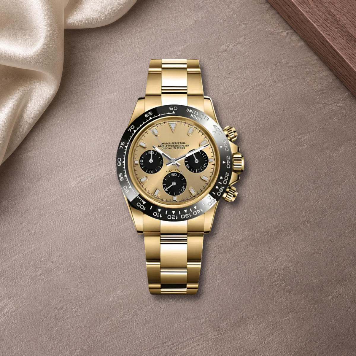 Speedline Gold and Champagne chronograph laid flat on mauve-gray ceramic with ivory silk