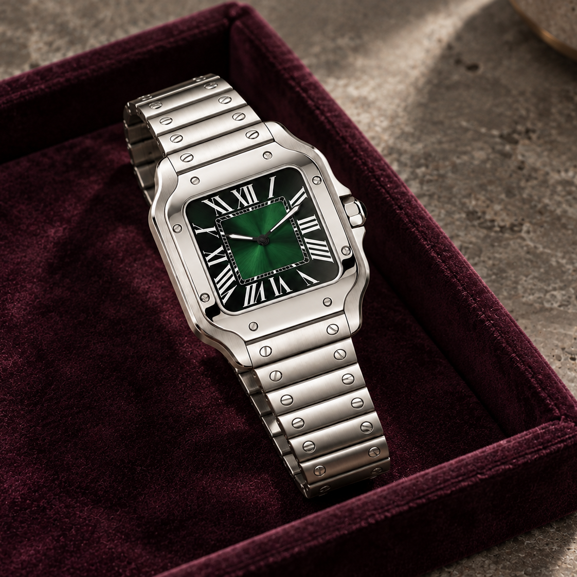 Santé Square Green Burst steel watch with green sunburst dial on a plum velvet tray and gray stone