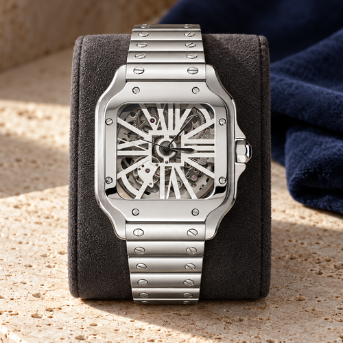 Santé Square Skeleton Classic silver watch upright on graphite cushion over travertine