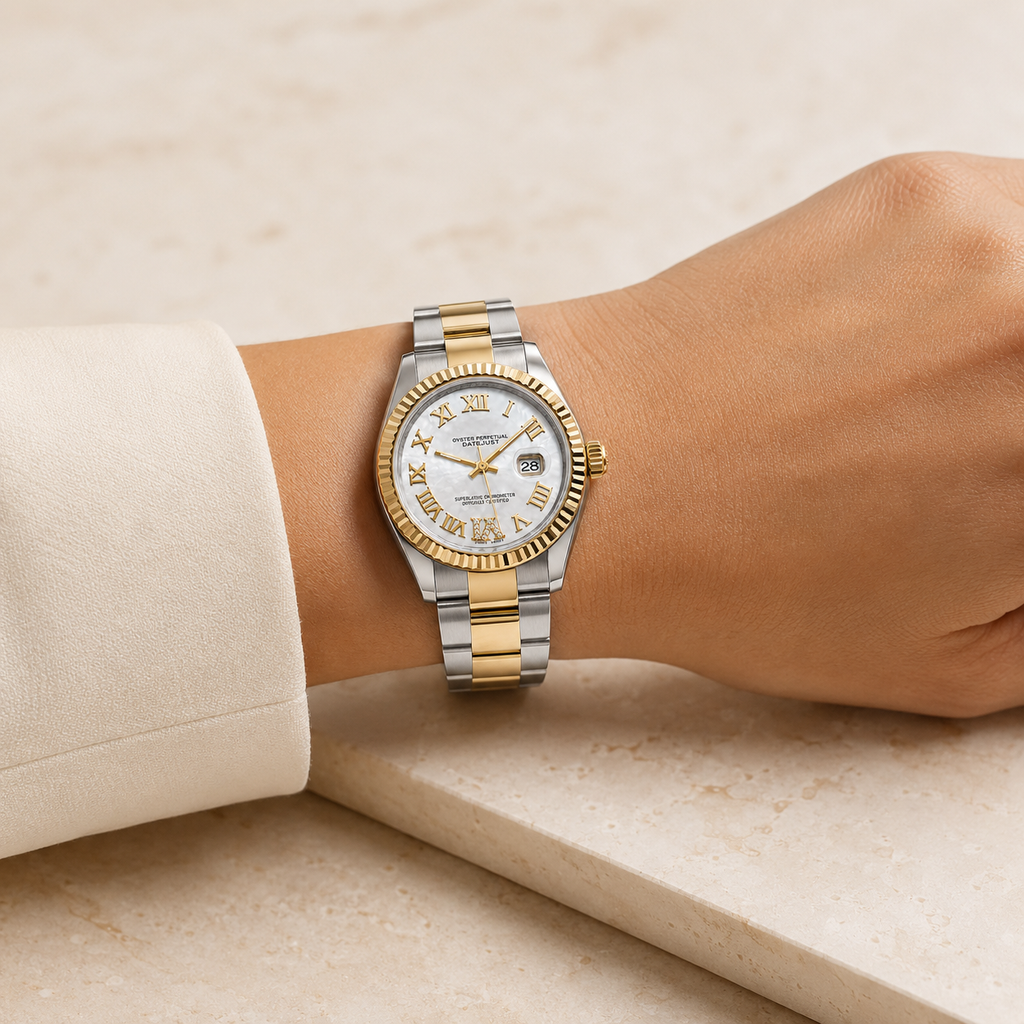 A two-tone stainless steel and gold wristwatch with a white dial and Roman numeral hour markers, shown worn on a person's wrist.