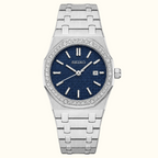 A Seiko women's watch featuring a silver stainless steel link bracelet, a bezel encrusted with clear crystals, and a textured dark blue dial with silver-tone hands and hour markers.