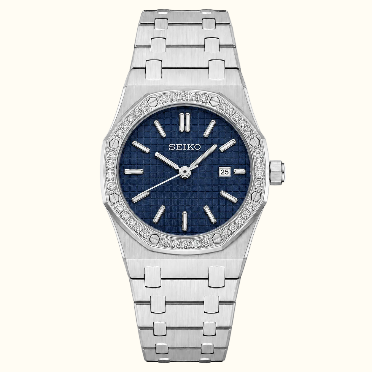 A Seiko women's watch featuring a silver stainless steel link bracelet, a bezel encrusted with clear crystals, and a textured dark blue dial with silver-tone hands and hour markers.