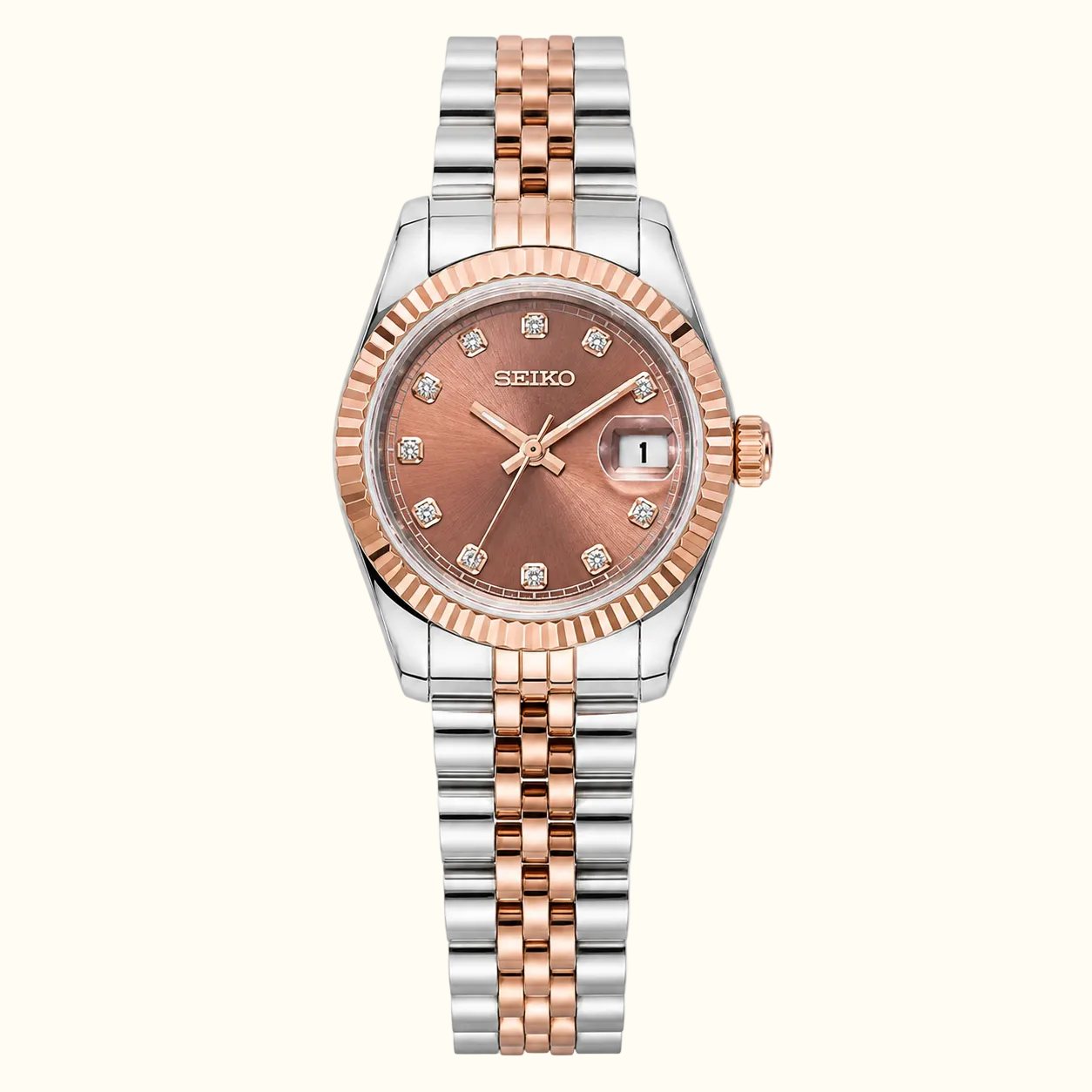 A Seiko women's two-tone watch with a rose gold dial and matching rose gold and silver link bracelet, shown on a solid white background.