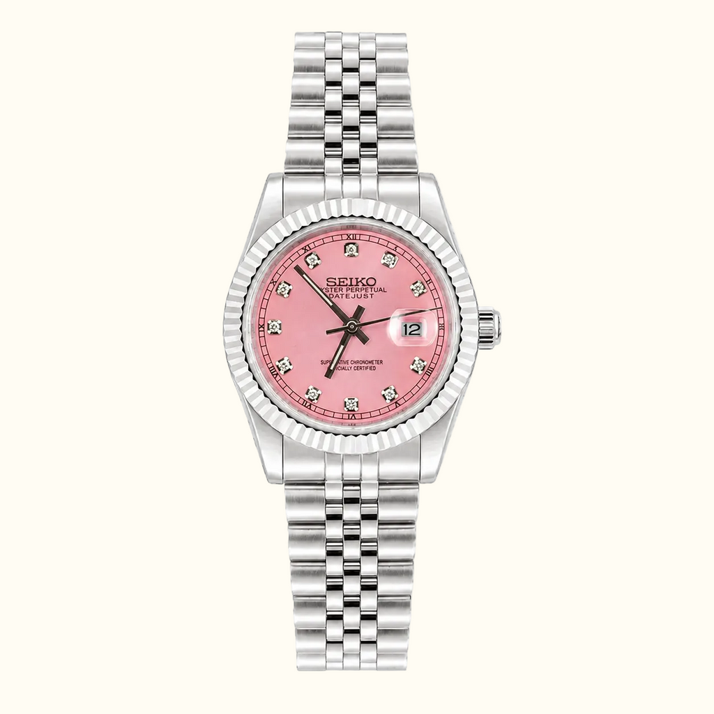 A Seiko women's watch featuring a silver-tone stainless steel Jubilee bracelet, a fluted bezel, and a pink dial with crystal hour markers.