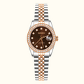 A Seiko women's automatic watch with a brown dial, a bezel set with small clear stones, and a two-tone stainless steel and rose gold link bracelet, shown on a plain white background.