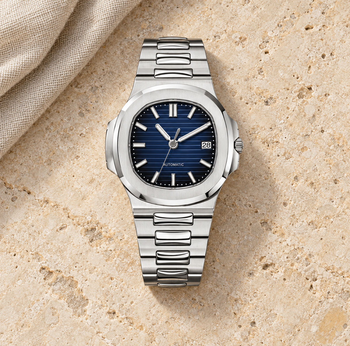 Nautiko Baltic blue-dial automatic watch laid flat on pale limestone with natural linen