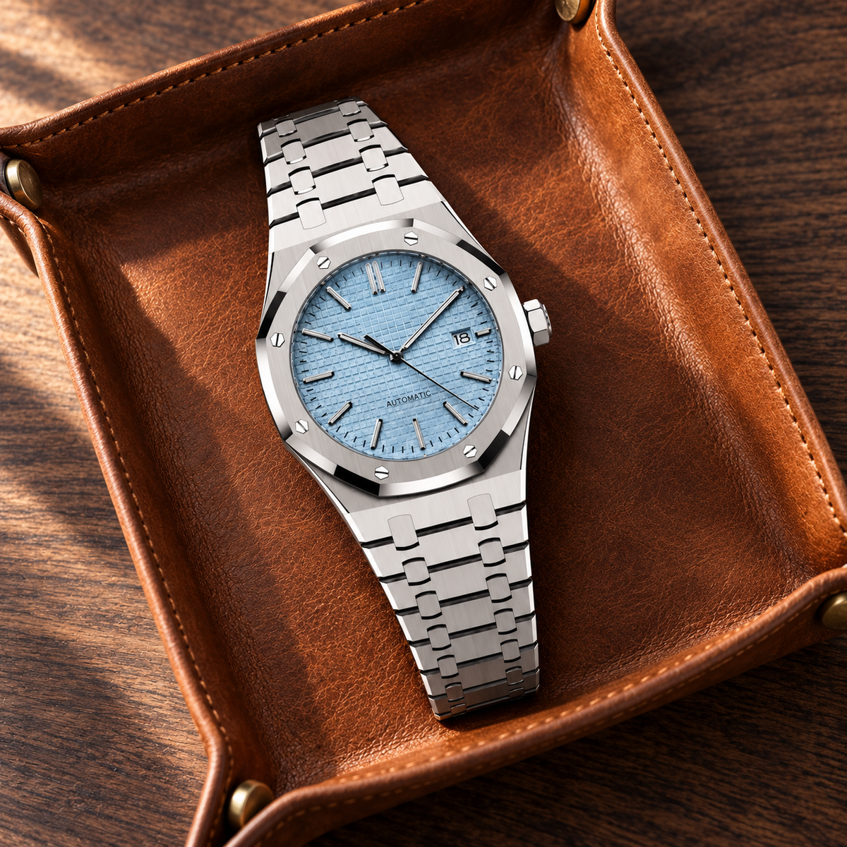 Aqua blue Royal Sportline watch in a cognac leather tray