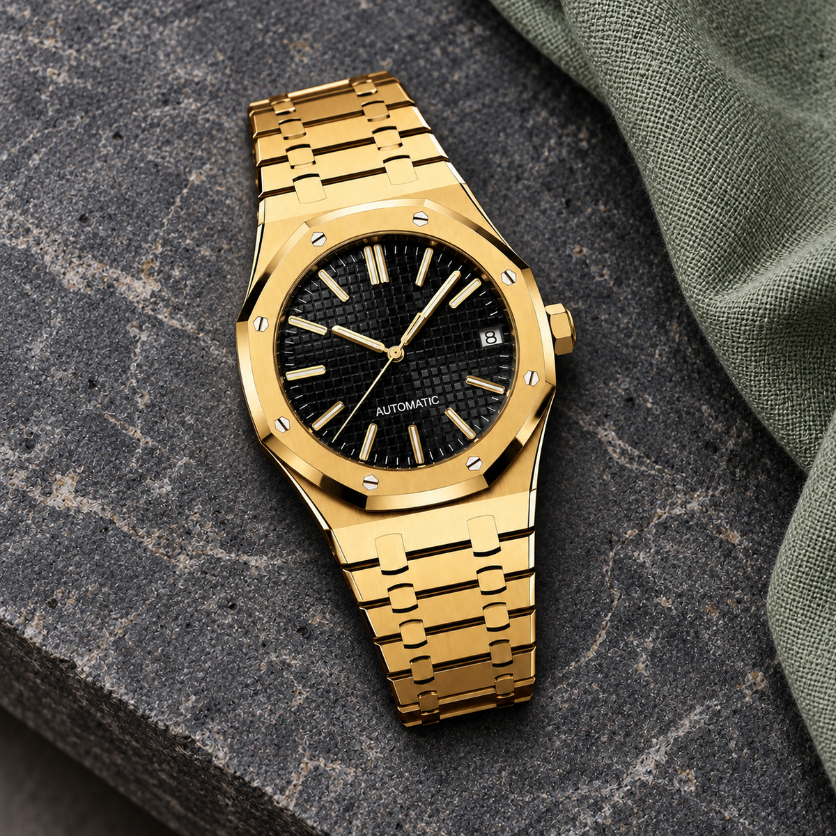 Gold and black Royal Sportline watch on charcoal limestone with sage linen