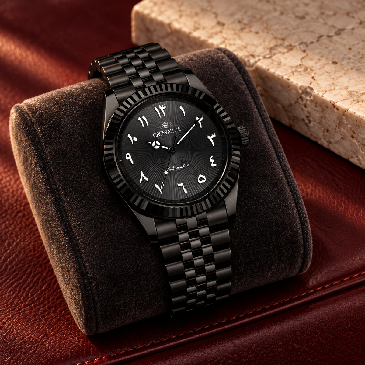 Black Arabic dial watch on charcoal velvet over burgundy leather and limestone