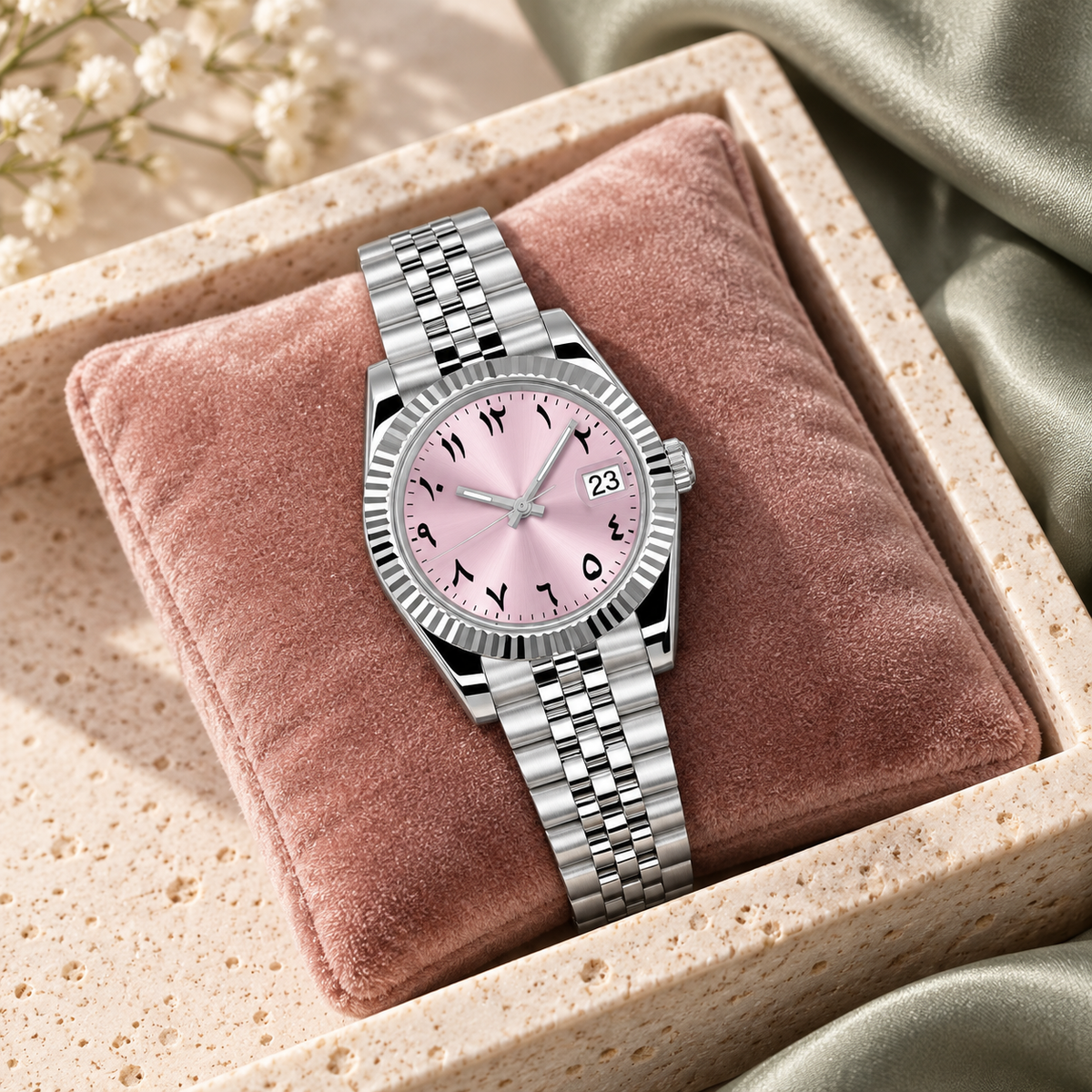 Blush pink dial watch on deep teal linen over pale pink marble
