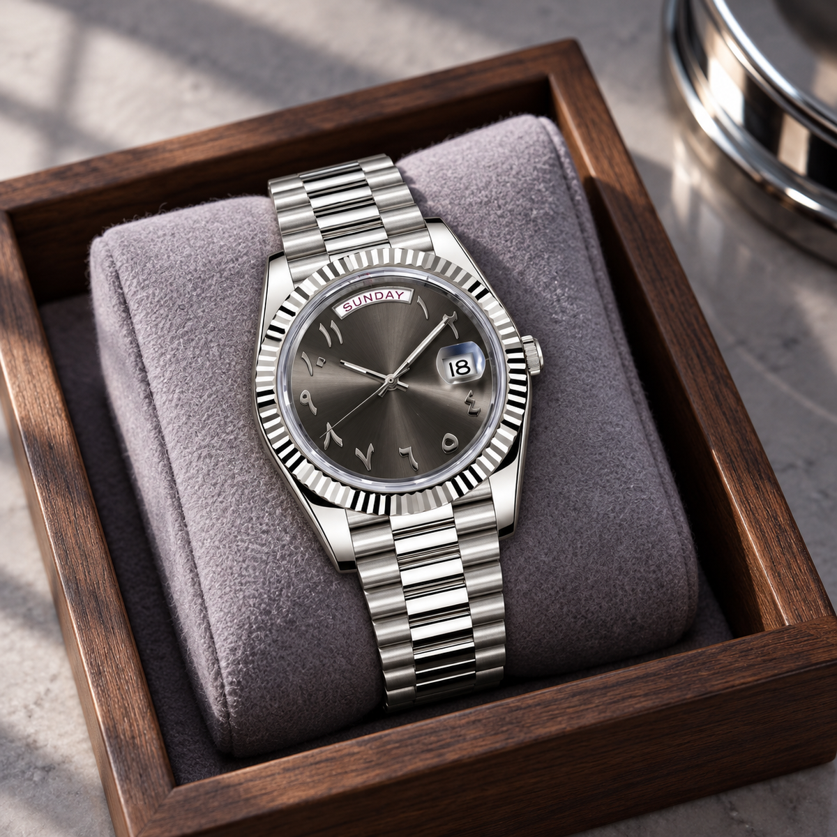 Slate grey dial watch on lilac wool cushion in walnut tray