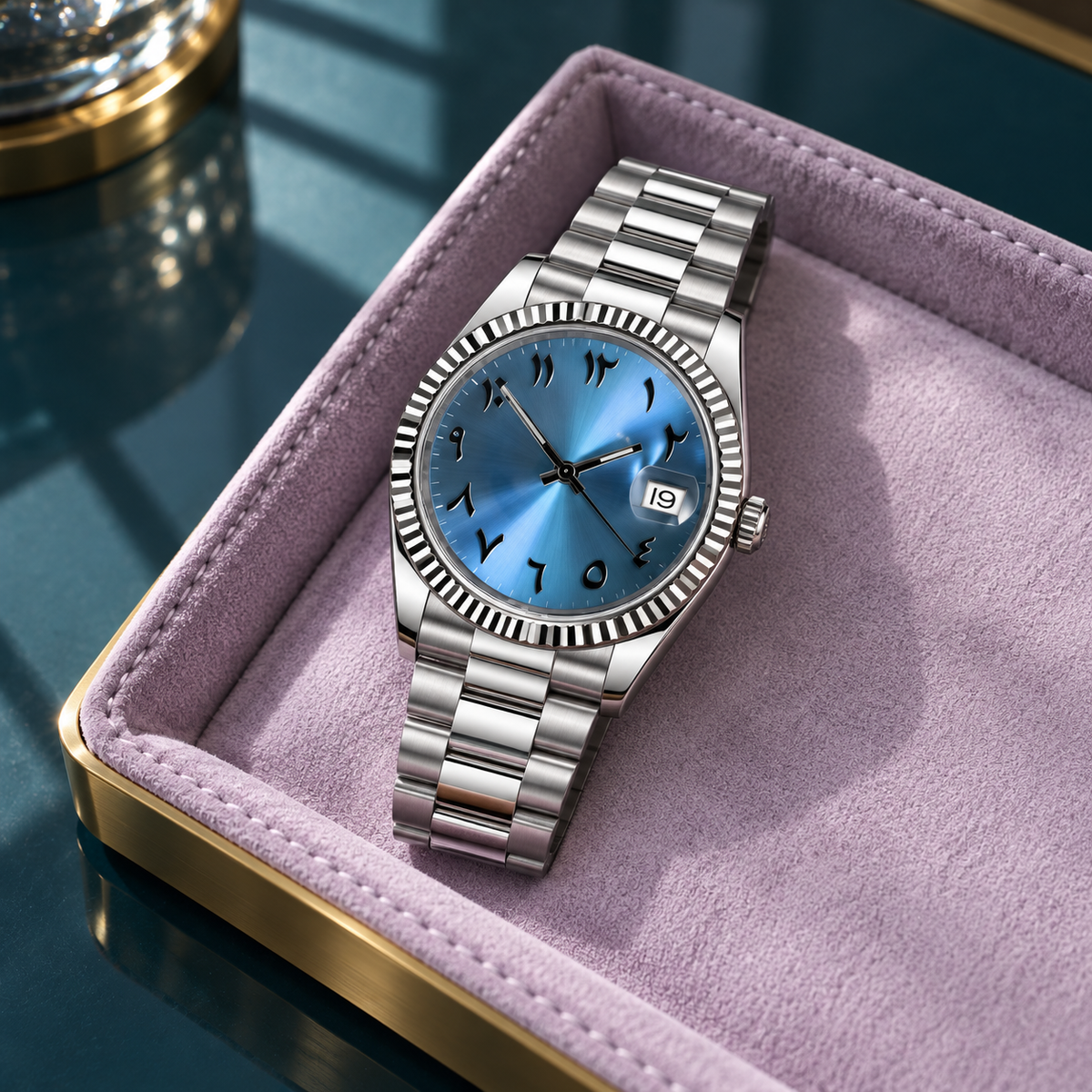 Ice-blue dial watch on rust cashmere and charcoal slate with ivory support