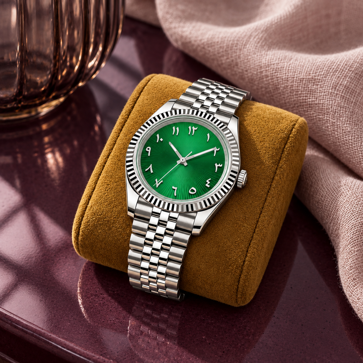 Emerald sunray Arabic numeral watch on a mustard display cushion with plum ceramic and blush linen