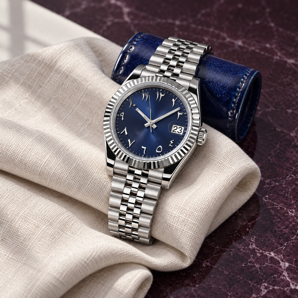 Navy dial watch on cream linen and cobalt ceramic over plum stone