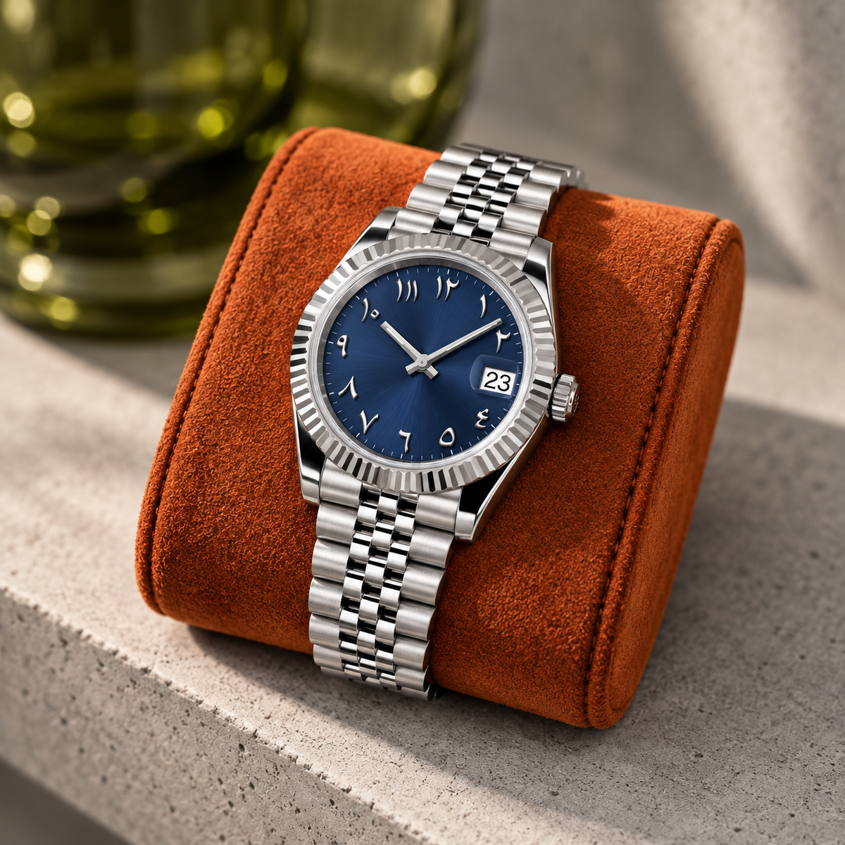 Navy blue watch on ochre leather travel cushion against charcoal