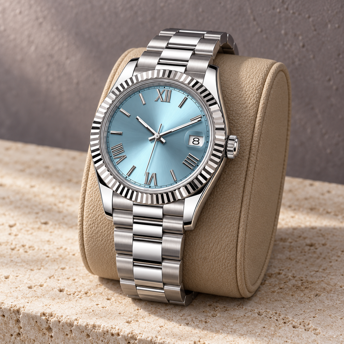 Side view of Crown Numeral Date Ice Blue on sand leather support with three-link bracelet