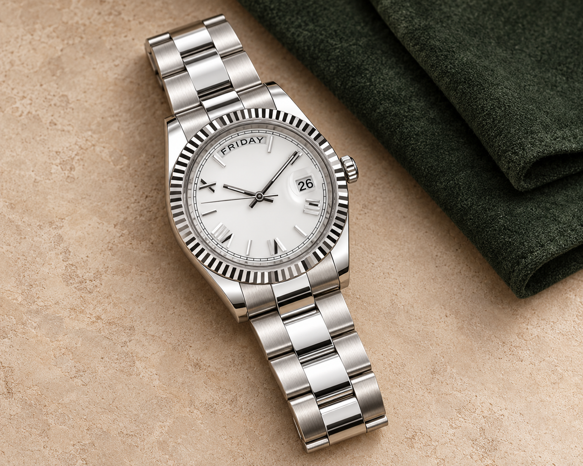 Dayline Ghost White watch with three-wide-link bracelet on warm stone