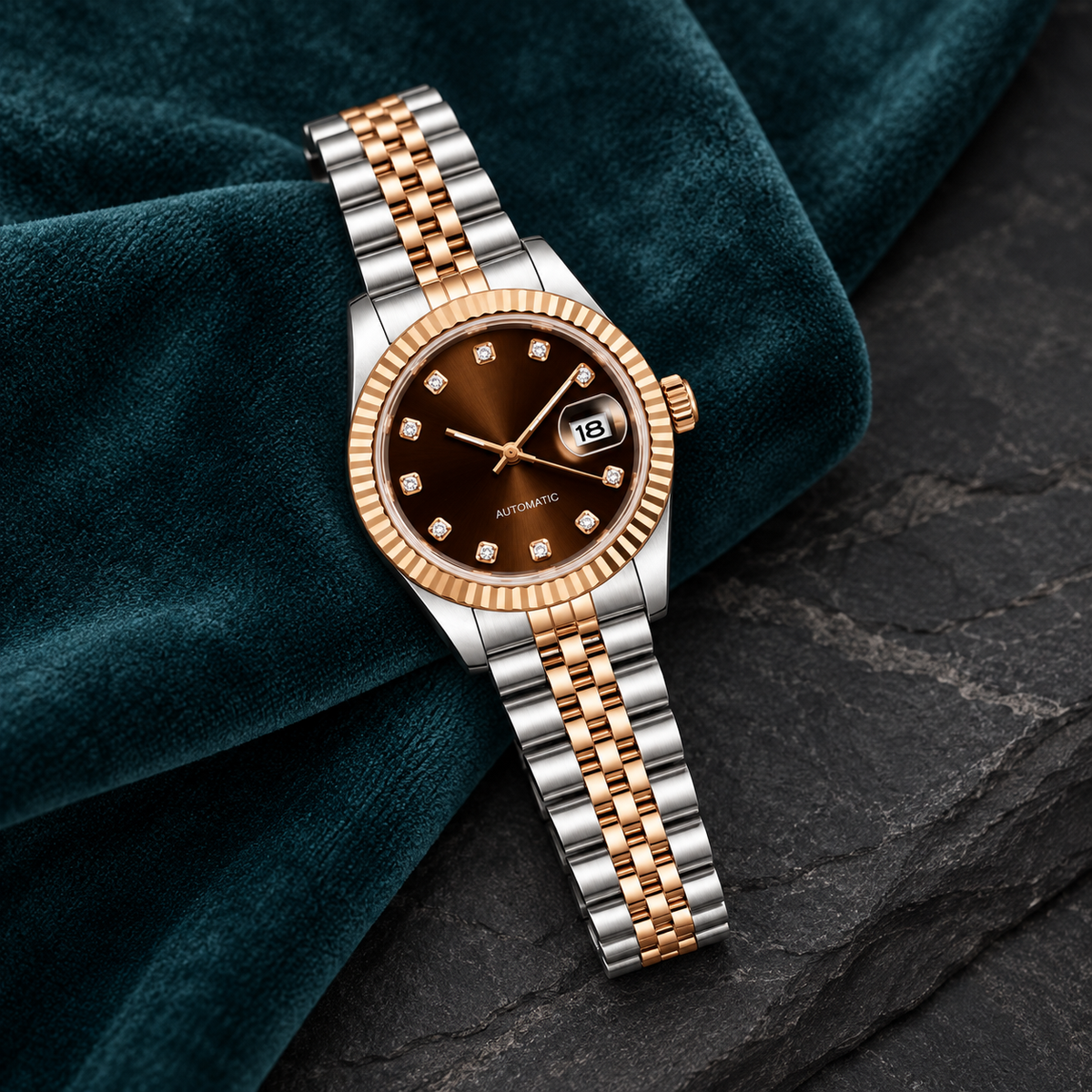 Lady Crownline Two-Tone Rose Gold Chocolate Crystal watch laid on deep teal velvet
