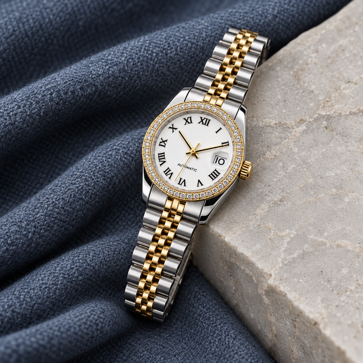 Lady Crownline Two-Tone White Roman Crystal watch with date 10 on slate-blue wool and pale stone
