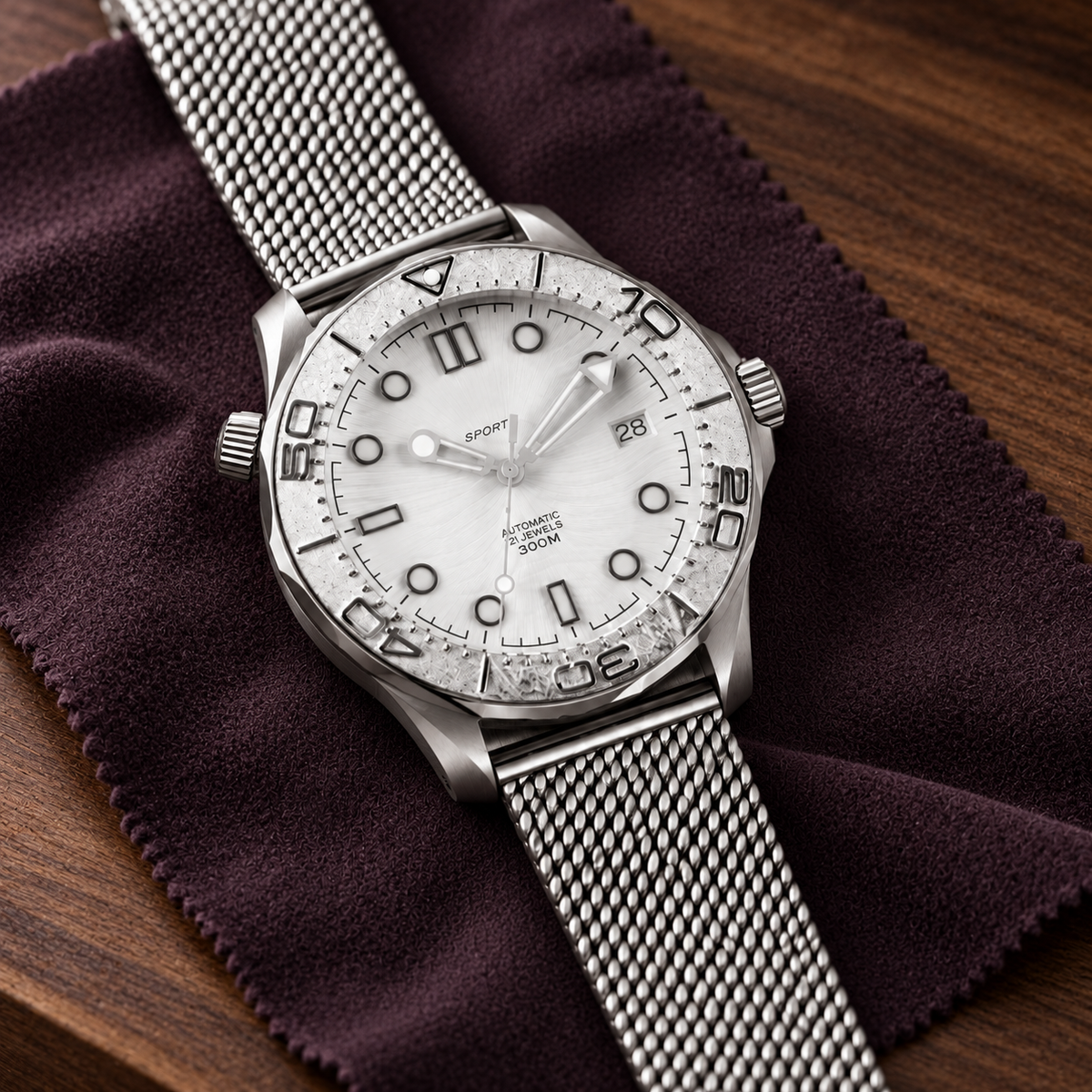 Oceanline Diver Glacier with date 28 and Milanese mesh bracelet laid on plum watchmaker mat over walnut