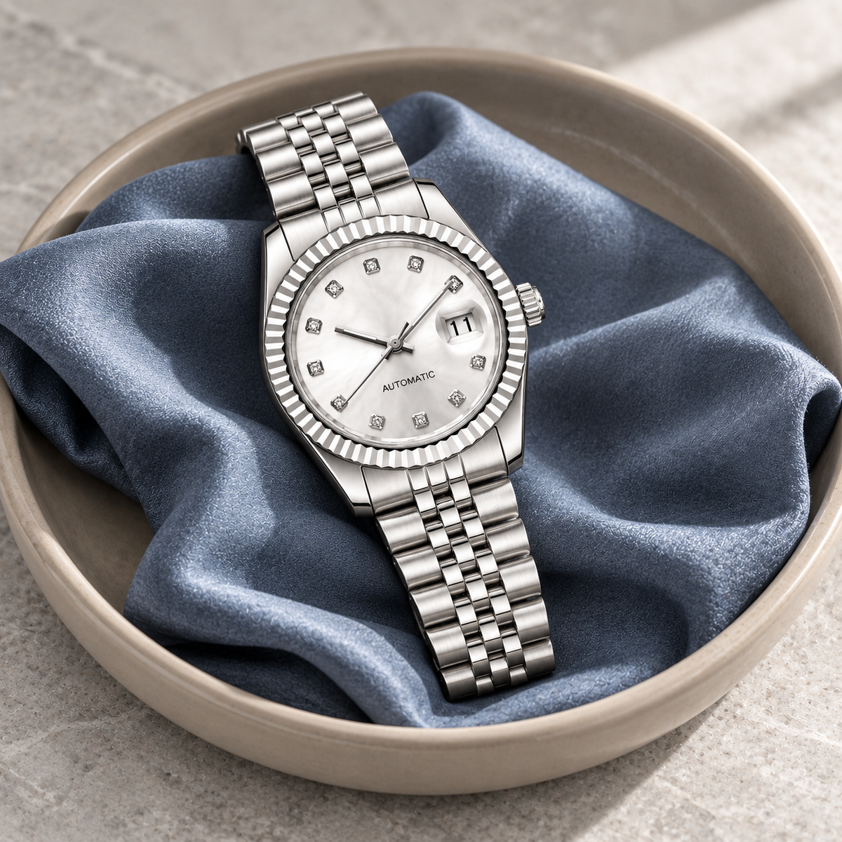 Lady Crownline Silver Crystal laid on slate-blue silk with date 11