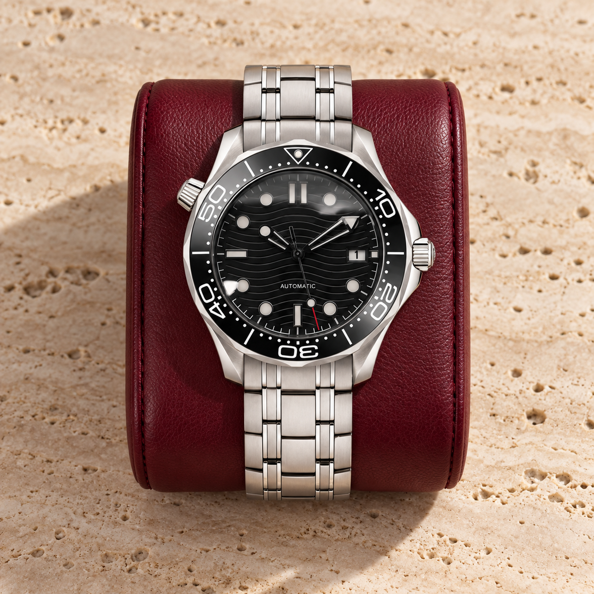Oceanline Diver Black on burgundy leather cushion and pale travertine