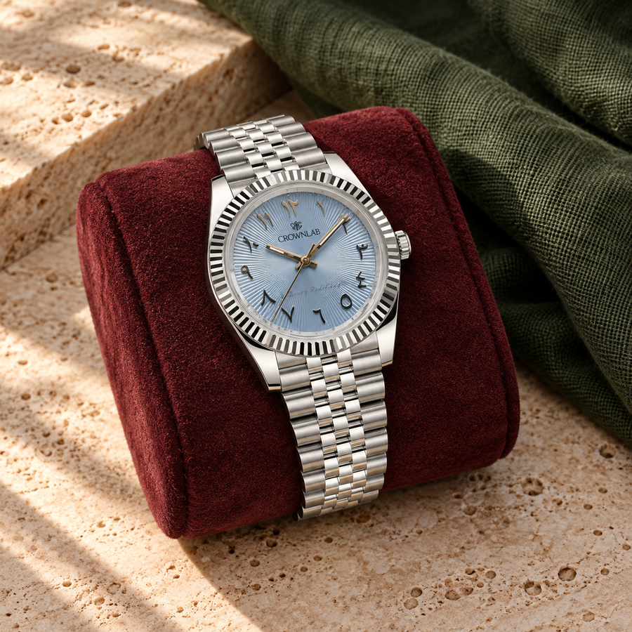 Arabic Heritage ice-blue sunray watch on burgundy suede above warm travertine