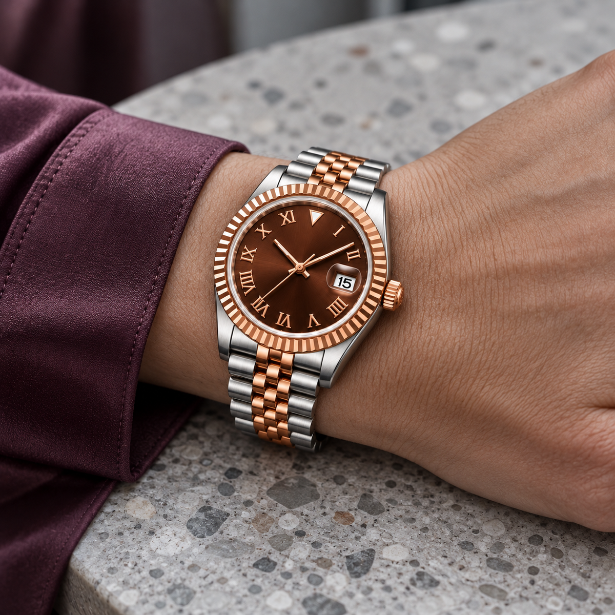 Two-Tone Rose Gold Chocolate Roman watch worn with plum silk cuff