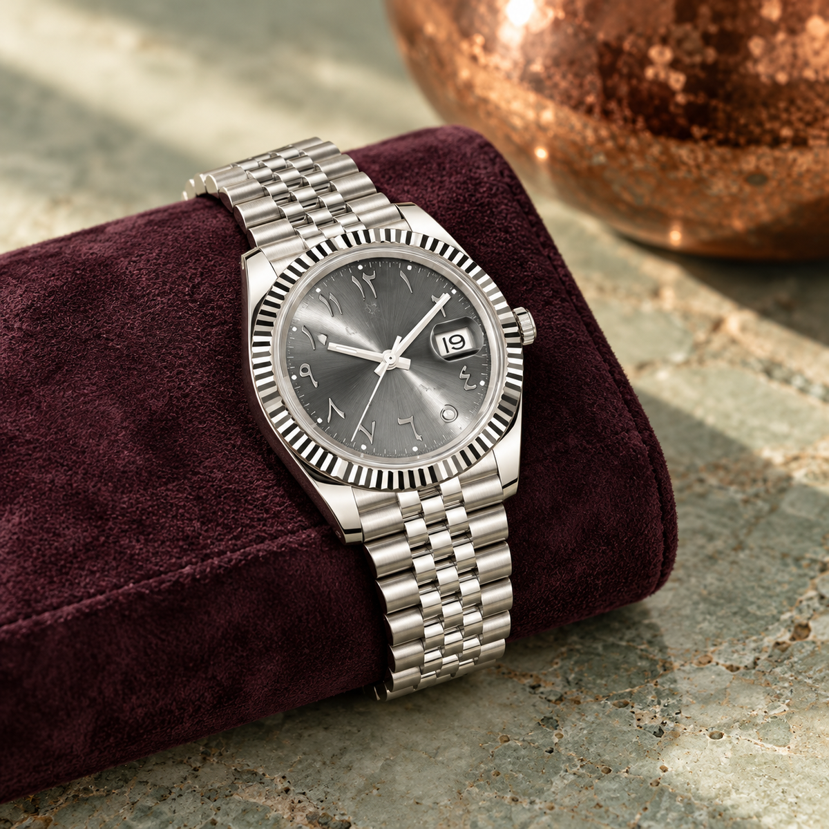 Arabic Heritage slate-grey watch on plum suede over celadon stone
