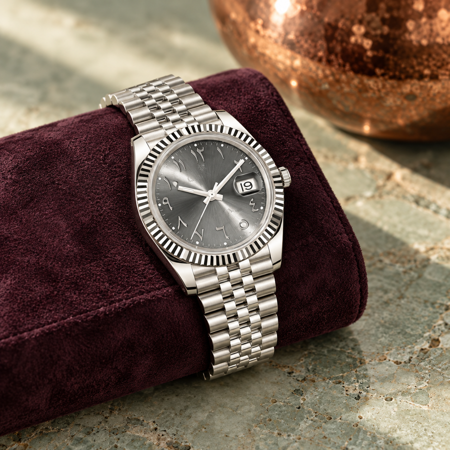Arabic Heritage slate-grey watch on plum suede over celadon stone