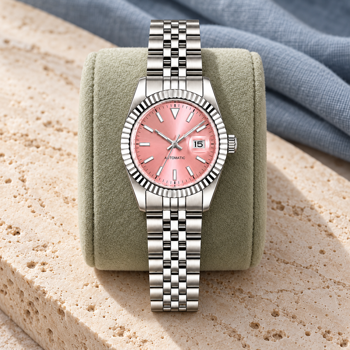 Lady Crownline Pink Dial watch displayed on sage velvet and travertine
