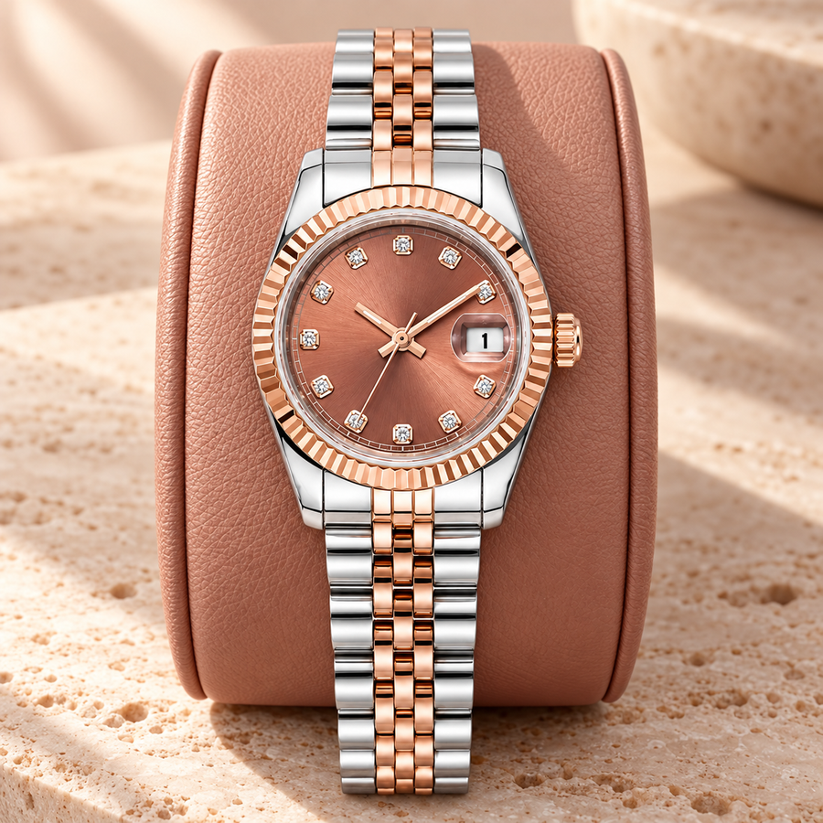 Lady Crownline Rose Blush Two-Tone watch on a rose leather display cushion over travertine; rose sunburst dial and two-tone five-link bracelet.