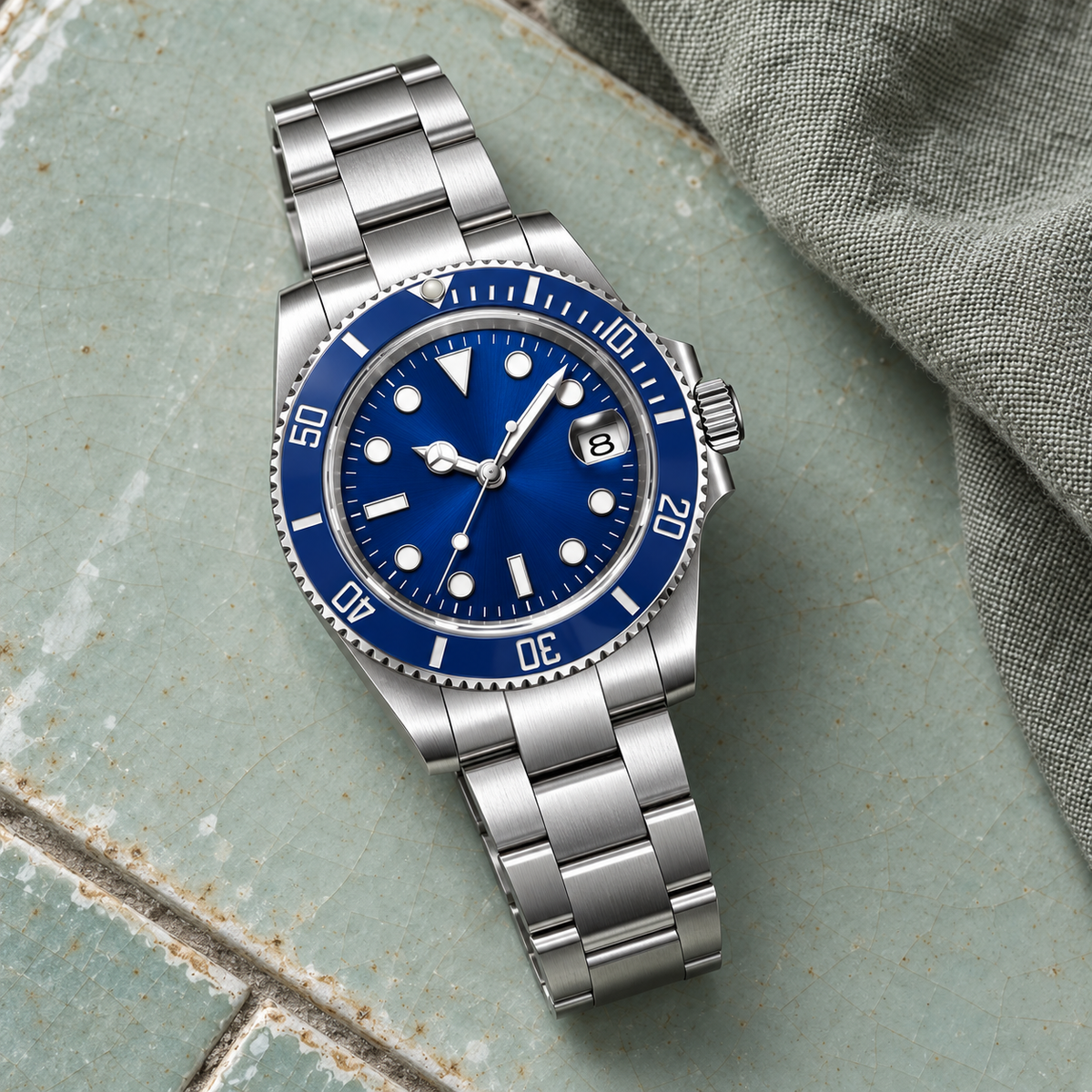 Marine Diver Abyss Blue Three-Link bracelet laid on celadon ceramic with gray-green linen
