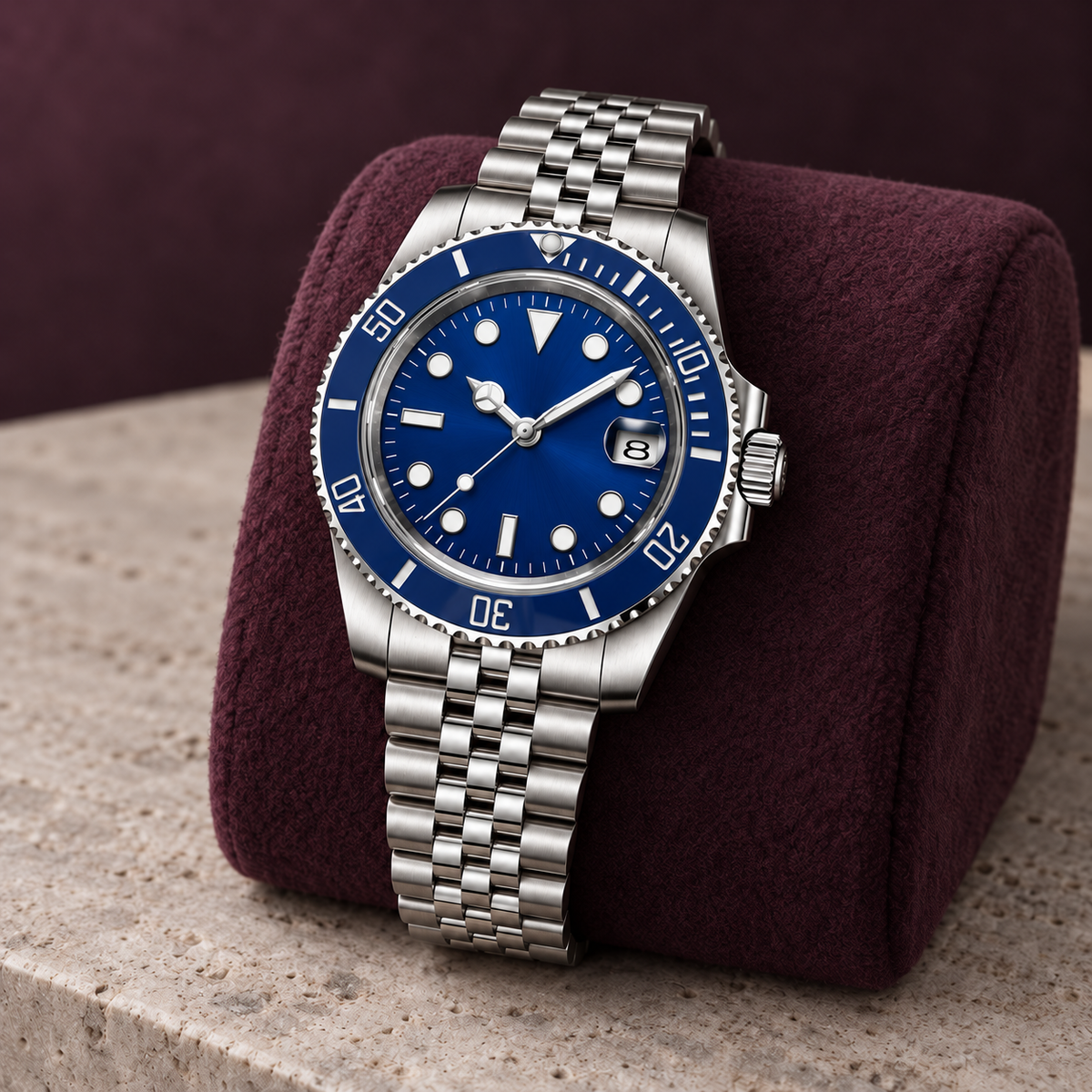 Marine Diver Abyss Blue Jubilee bracelet on aubergine wool cushion over pale limestone