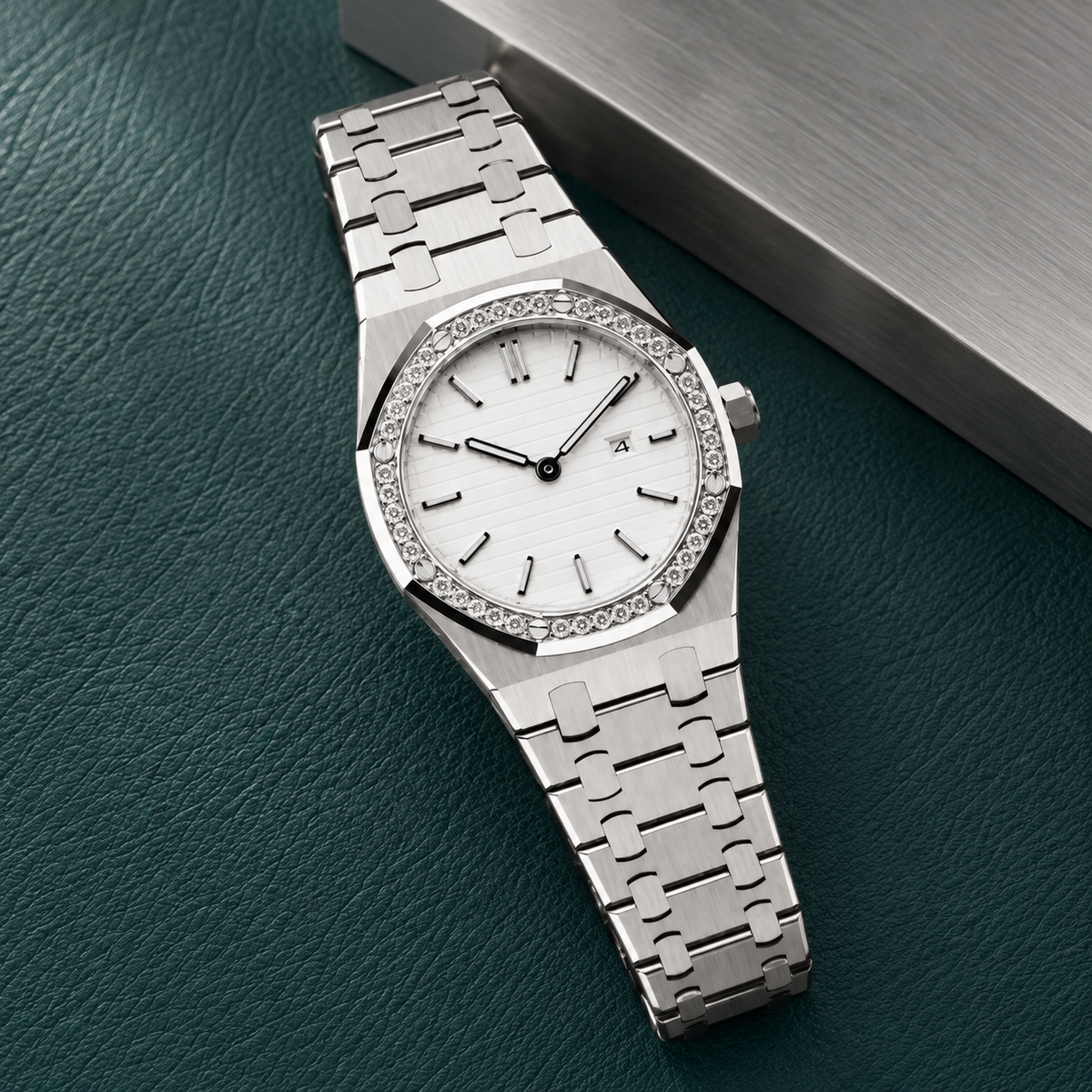 Royal Lady White Silver Iced watch laid on deep teal leather, showing its white horizontal dial, crystal-set bezel, date window and integrated steel bracelet.