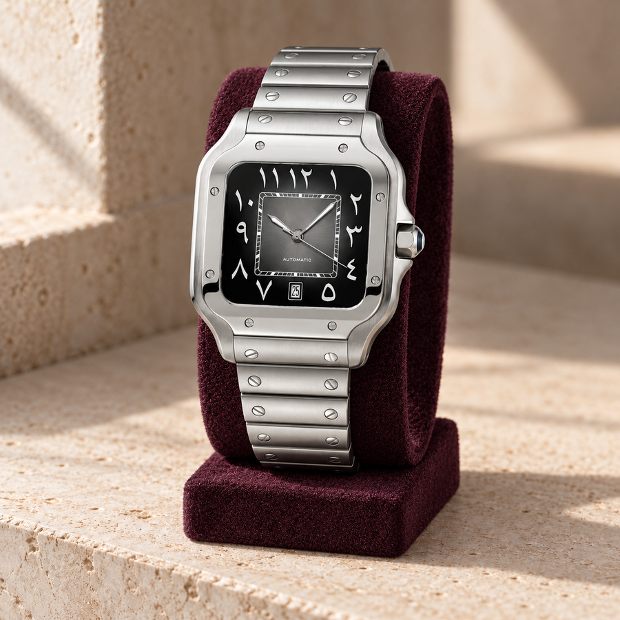 Santé Square Arabic Dark Gray steel watch on an aubergine suede display over travertine