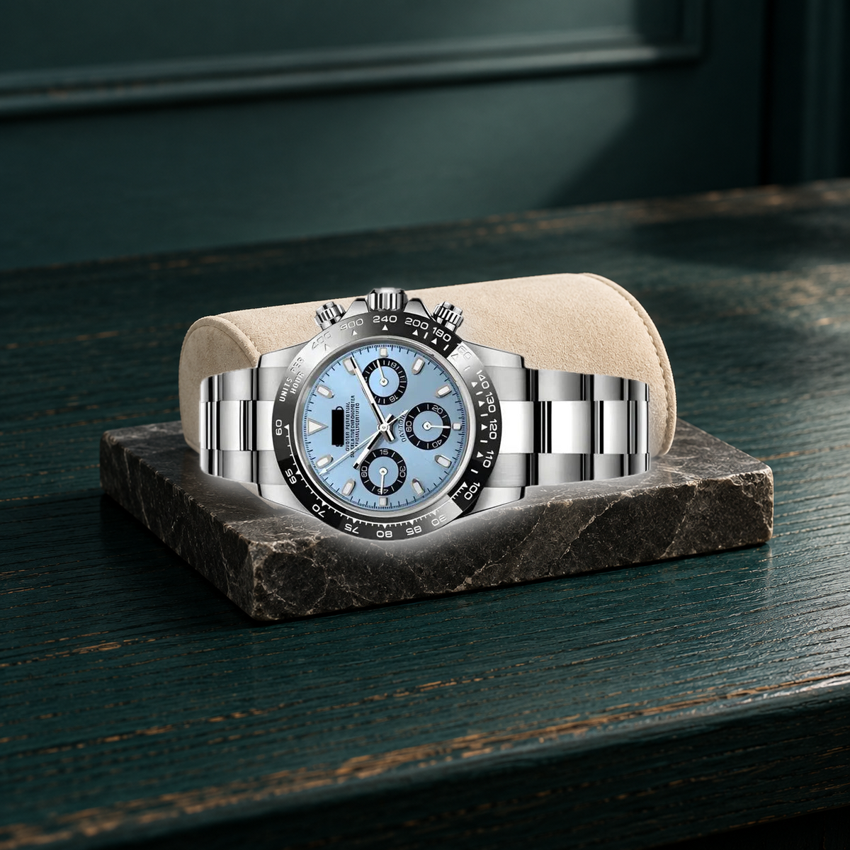 Sky-blue chronograph laid horizontally on cream nubuck over teal oak