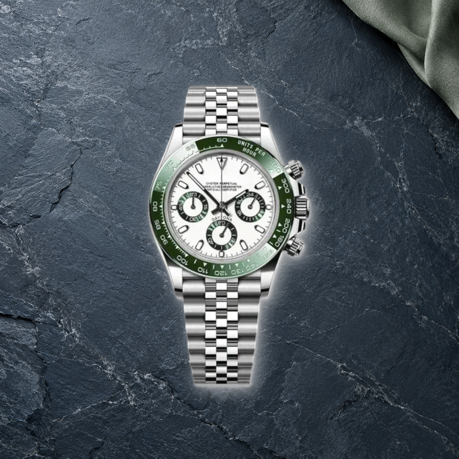 Speedline Alpine Green Racer chronograph lying face-up on blue-gray slate and sage suede