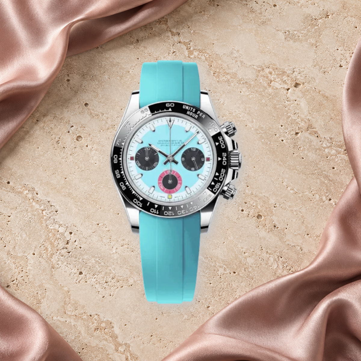 Speedline Baby Blue chronograph lying face-up on rose silk and ivory limestone