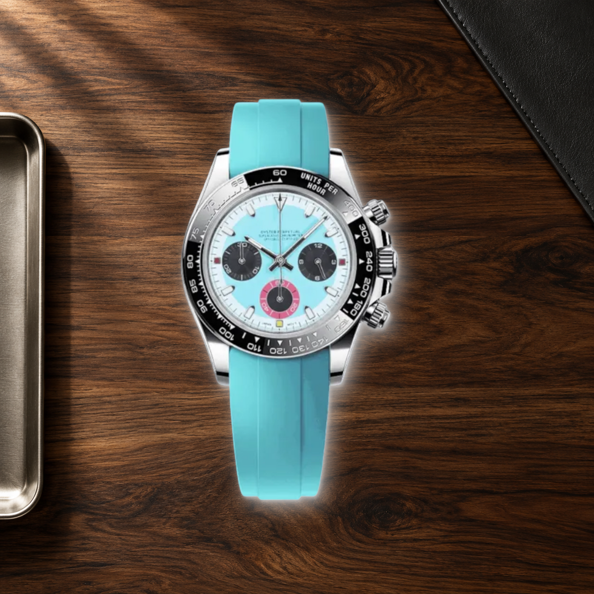 Speedline Baby Blue chronograph lying face-up on dark walnut beside leather