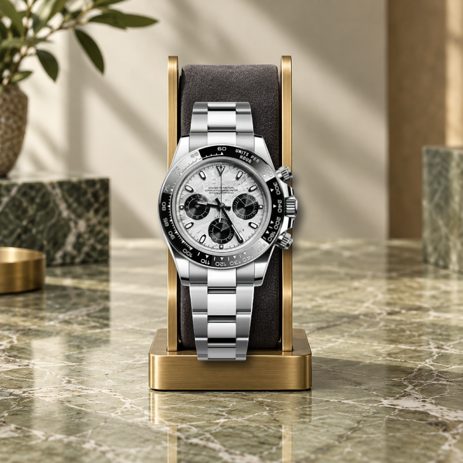 Meteorite VK63 chronograph on a charcoal cushion and brass display stand, olive marble setting