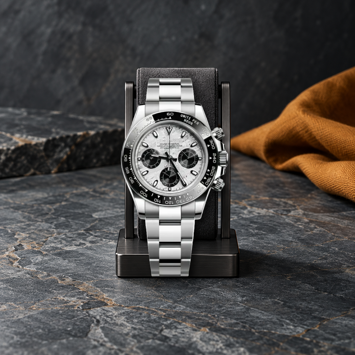 Meteorite VK63 chronograph on a charcoal display stand, smoke-blue stone and saffron linen