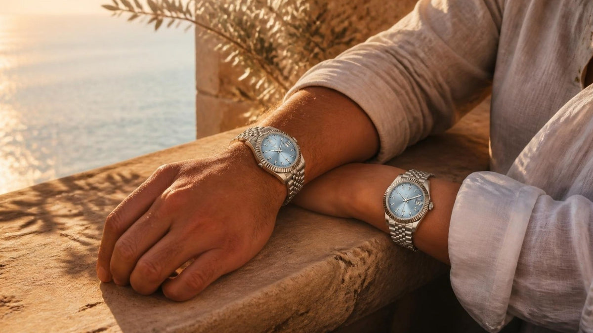 Two wrists wearing CrownLab Crownline Date watches on a stone ledge at sunset